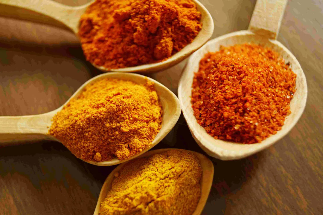 Wooden spoons with colorful spices highlighting turmeric’s health benefits as a detoxifying agent