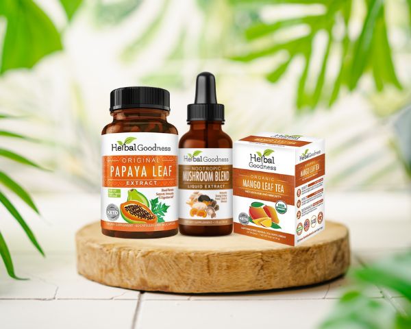 Natural supplement bottles including Papaya Leaf Extract and Moringa Leaf Capsules on wood