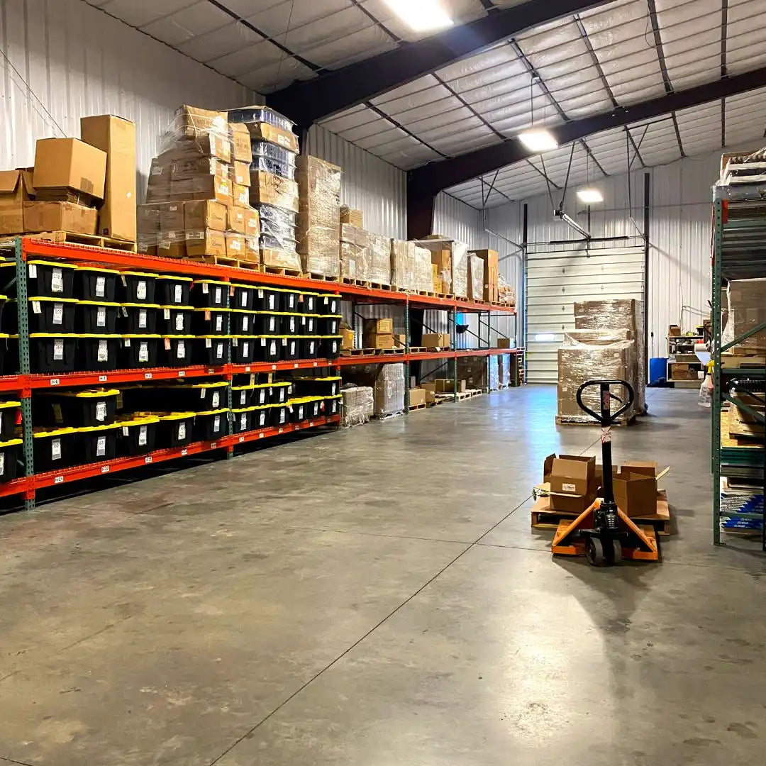 Industrial warehouse storage rack system with stacked boxes and pallets.